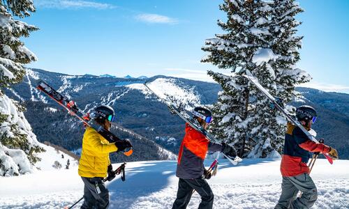 Group of three individuals skiing on a mountain