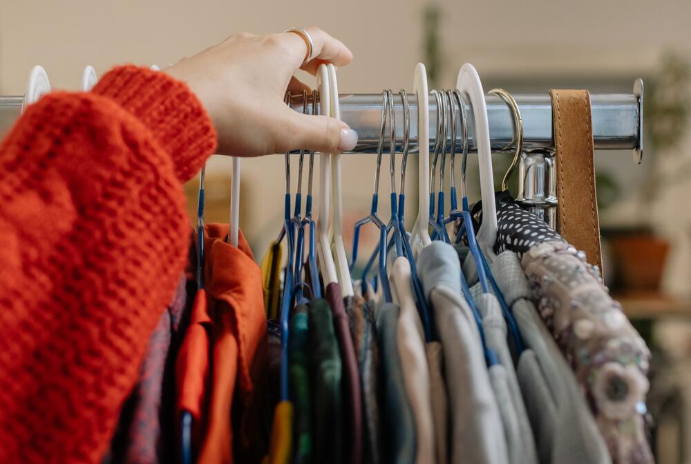 Woman touching clothes hanger.