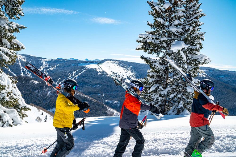 Group of three individuals skiing on a mountain